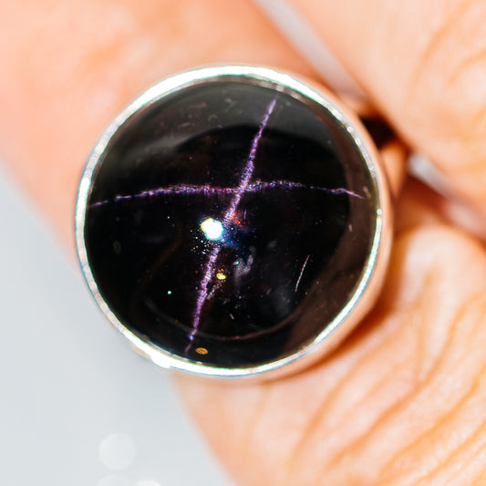 Sterling silver ring with black star garnet cabochon and purple star effect