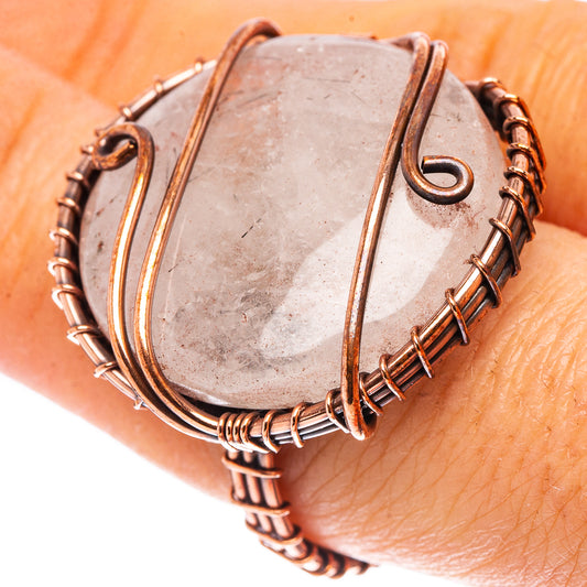 Oxidized copper wire-wrapped ring with white quartz oval stone, close-up