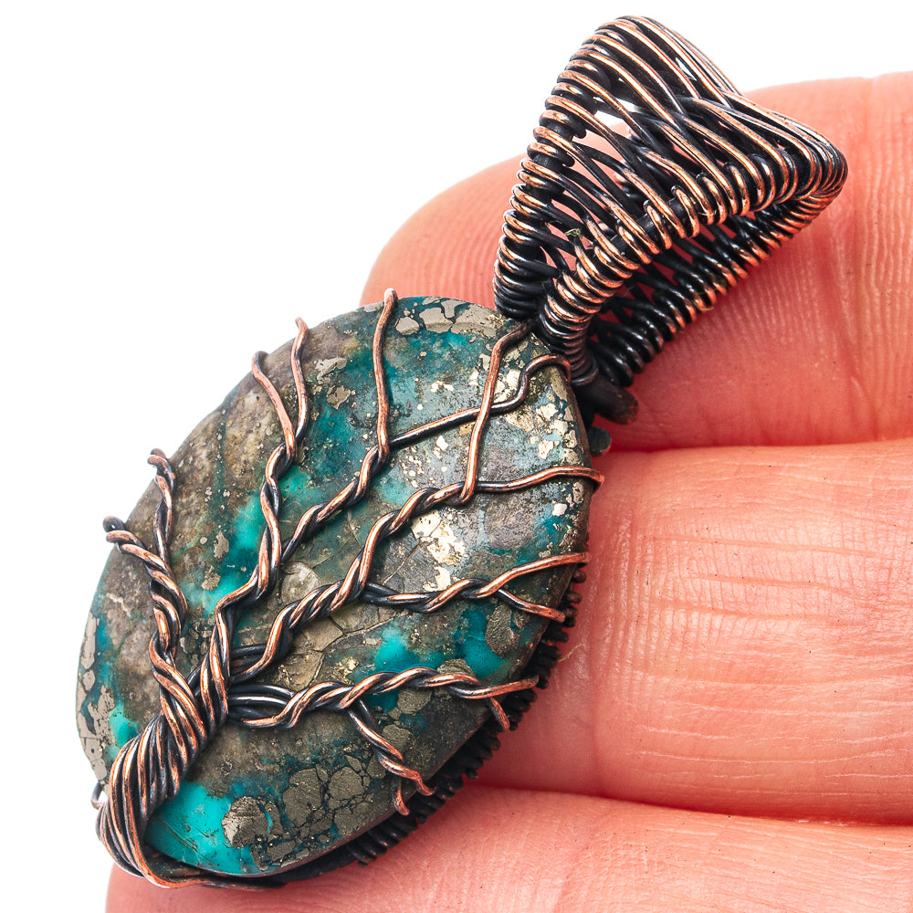 Oval turquoise stone pendant with oxidized copper tree-of-life wirework