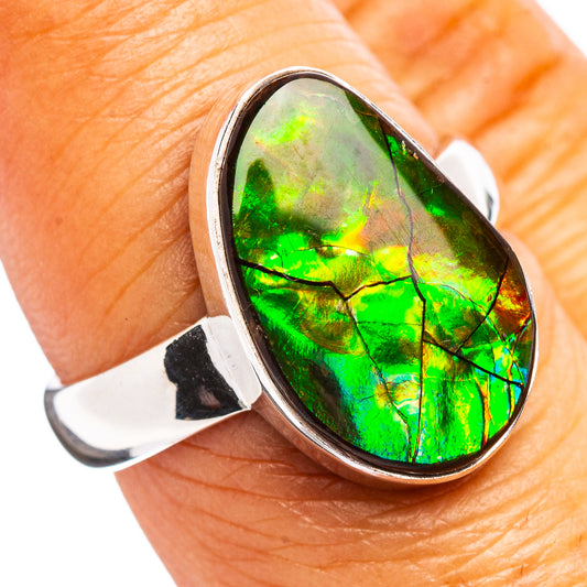 Teardrop ammolite ring with bright green iridescent stone in silver setting