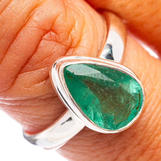 Sterling silver ring close-up with faceted green emerald in bezel