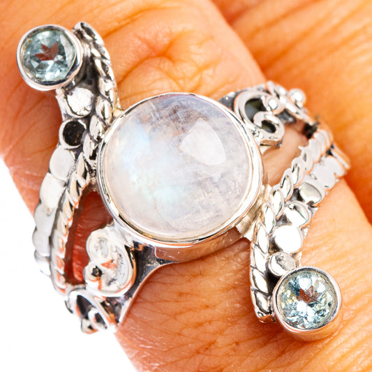Sterling silver ring with round rainbow moonstone center and blue topaz side stones