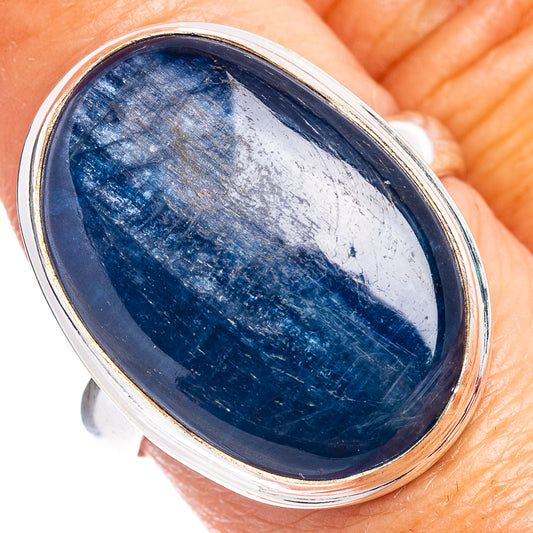 Oval blue cabochon stone in silver bezel on size 9 ring, angled view