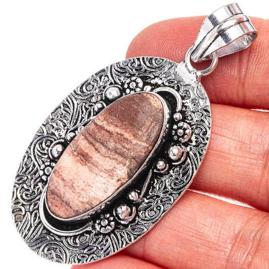 Coconut jasper oval pendant in German silver, ornate filigree bezel with loop bail