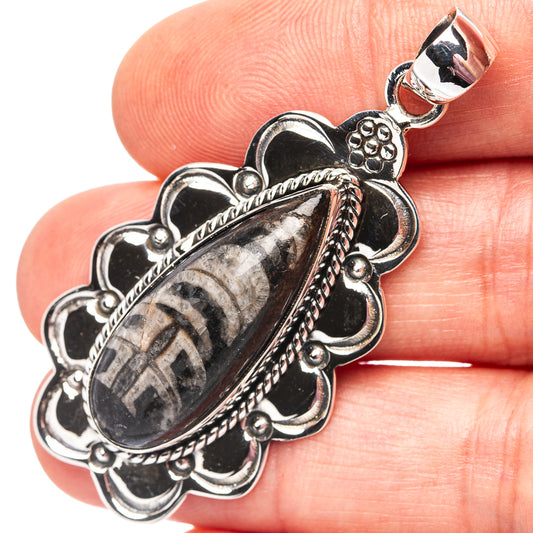 Sterling silver orthoceras fossil pendant with oval stone and floral settings