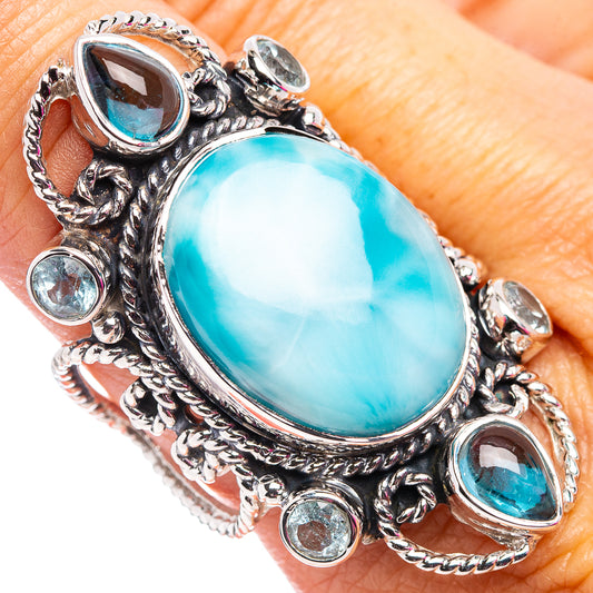 Sterling silver ring with oval turquoise larimar center and blue topaz accents