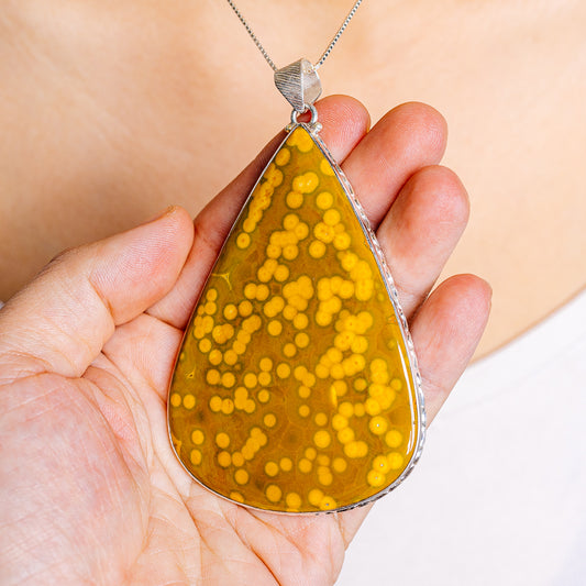 Ocean jasper teardrop pendant in .925 sterling silver, amber yellow stone detail