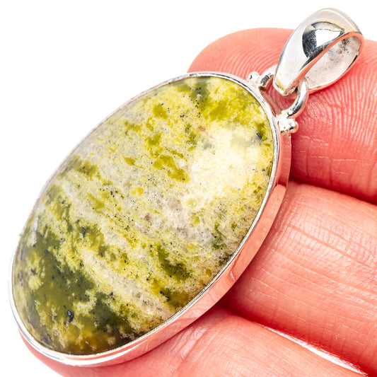 Oval lizardite pendant in .925 sterling silver bezel with hinged bail, close-up