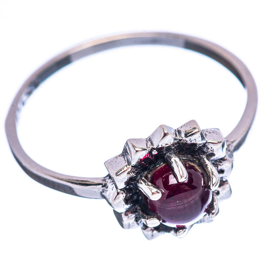 Sterling silver garnet ring with dark red round center and prong-set halo cluster