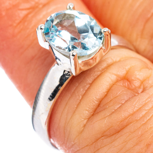 Oval blue topaz ring in .925 sterling silver with four-prong faceted gemstone, close-up