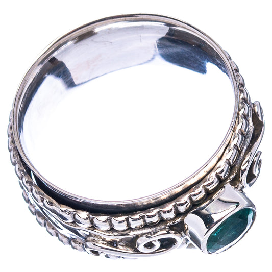 Sterling silver ring with green gemstone bezel and detailed scalloped band, top view