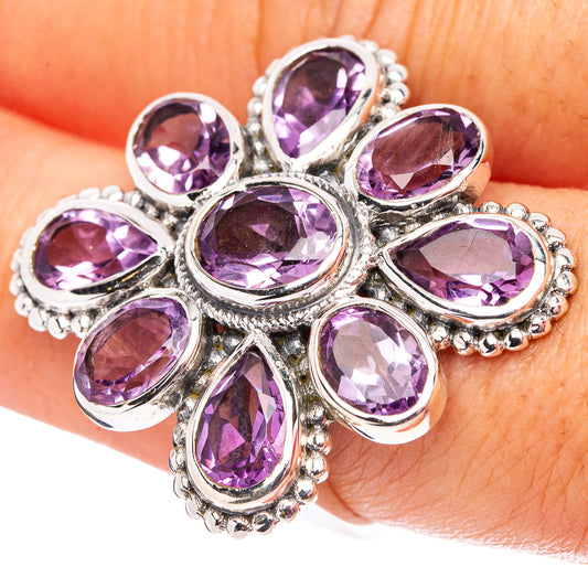 Amethyst flower ring on finger, oval purple gemstones with silver prong setting