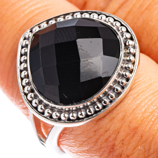 Sterling silver ring with black faceted oval gemstone, beaded halo setting