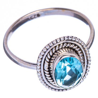 Sterling silver oval blue topaz ring with raised ornate bezel, side profile