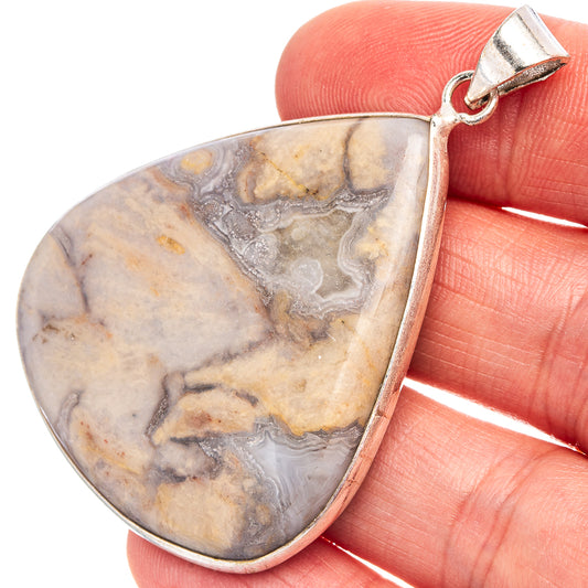 Silver-plated teardrop pendant with marbled rhyolite stone and top bail