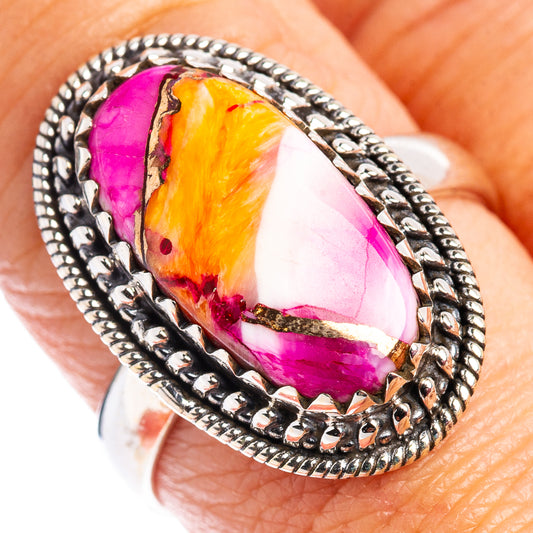 Sterling silver ring with oval pink-orange floral style stone and decorative frame