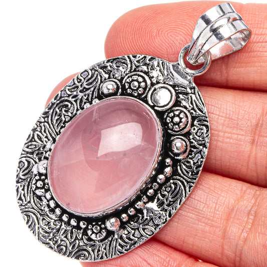Rose quartz pendant with oval pink stone in ornate German-silver frame