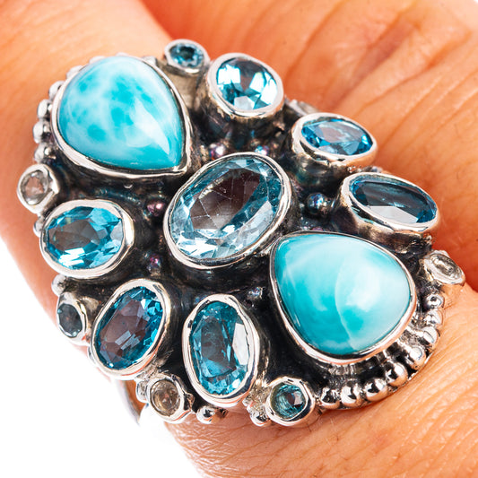 Sterling silver statement ring with oval Larimar-style stone and blue topaz accents.