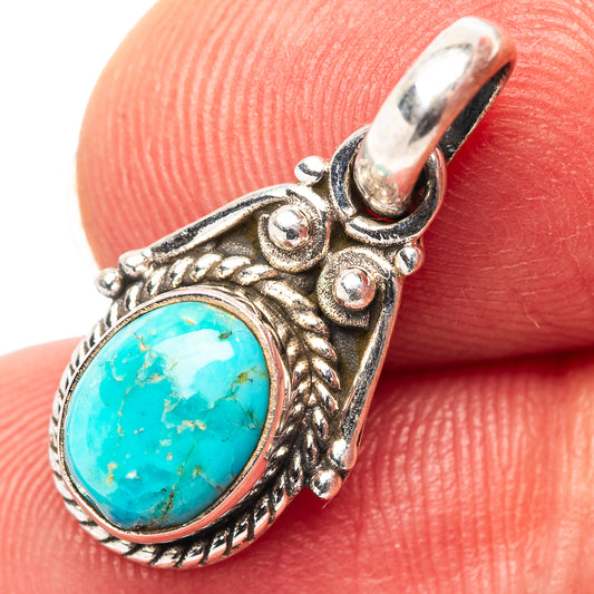 Turquoise pendant on .925 sterling silver frame, oval cabochon with ornate border