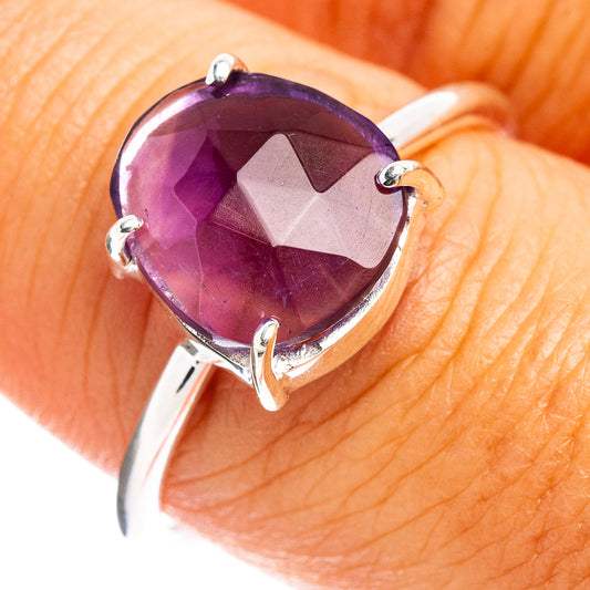 Faceted oval amethyst ring on sterling silver band with four prongs