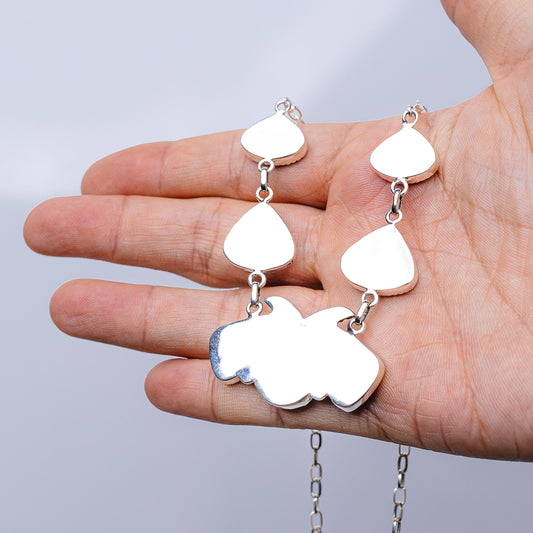 Turquoise stone drop earrings with silver teardrop and leaf-like charms