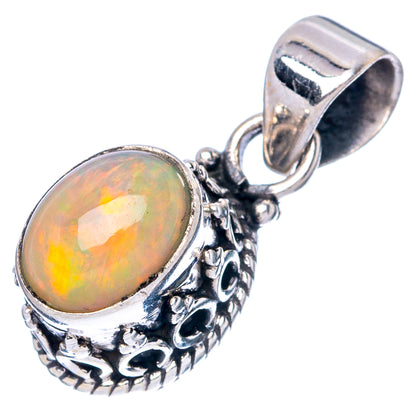 Round opal cabochon pendant with detailed filigree border and hinged bail, sterling silver