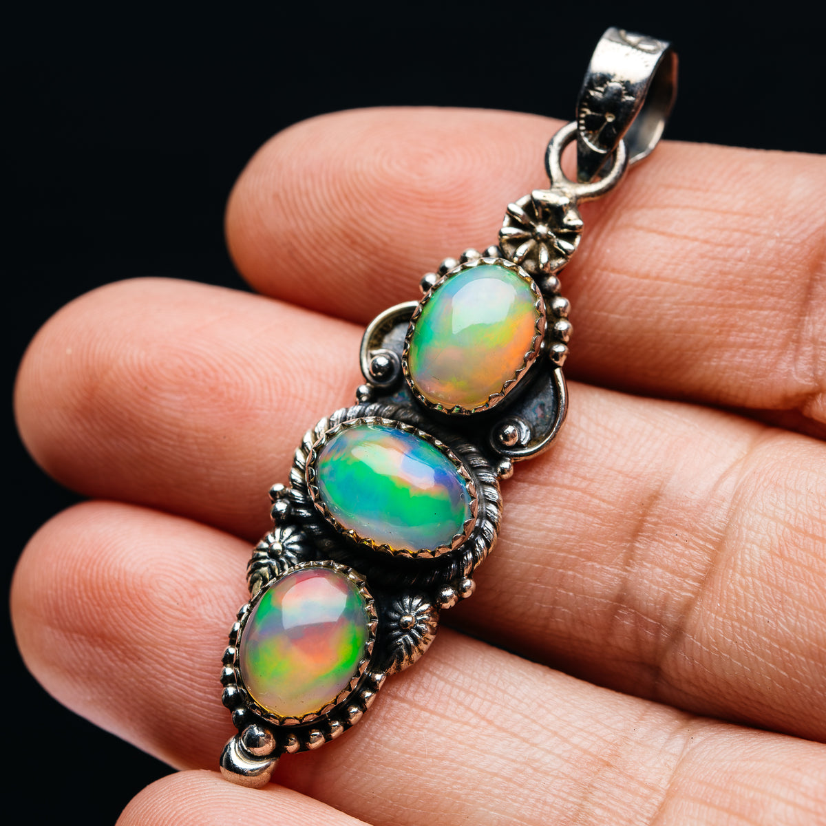 Sterling silver pendant with three oval Ethiopian opal gems in ornate bezel setting