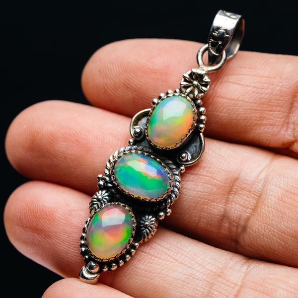 Sterling silver pendant with three oval Ethiopian opal gems in ornate bezel setting