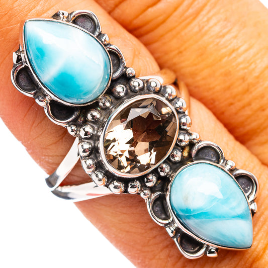 Sterling silver ring with two oval blue stones and round faceted center stone, size 8
