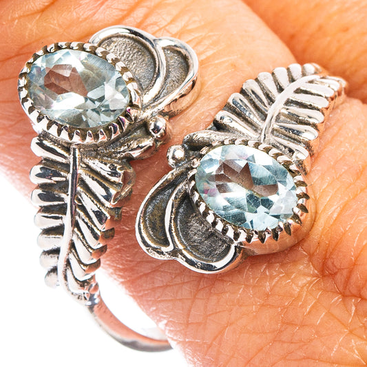 Sterling silver ring with two oval faceted light blue stones in ornate prong settings