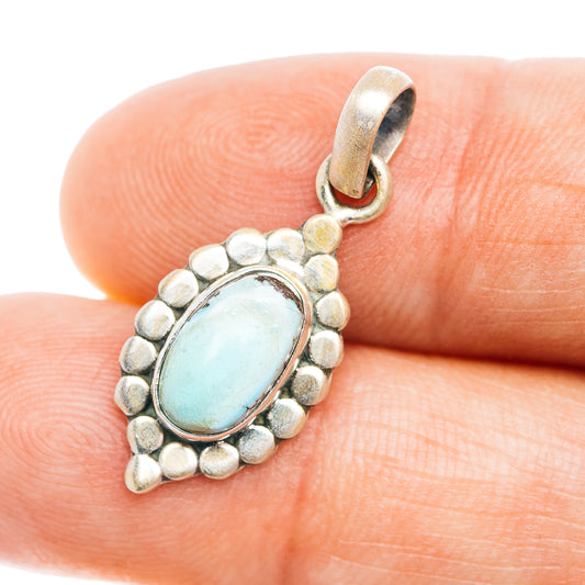Sterling silver pendant with oval blue-green turquoise cabochon and beaded border