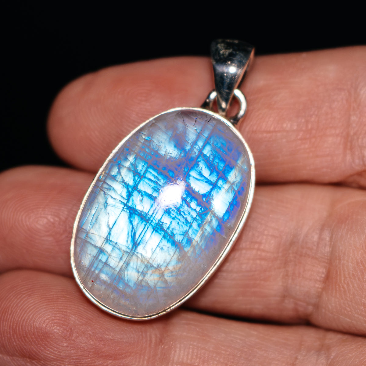 Oval rainbow moonstone pendant in .925 sterling silver bezel setting