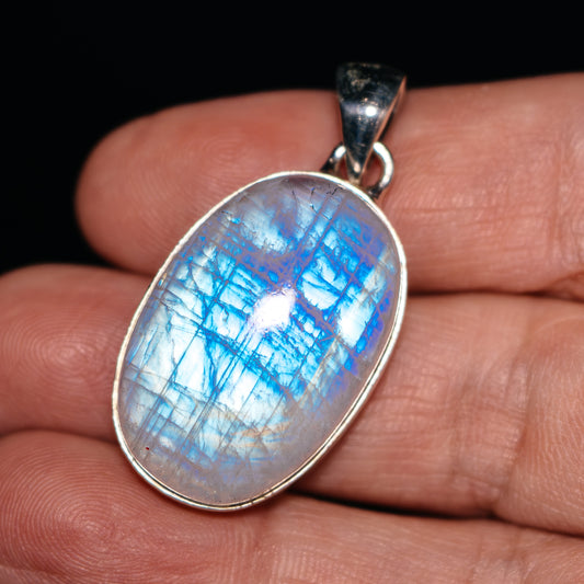 Oval rainbow moonstone pendant in .925 sterling silver bezel setting