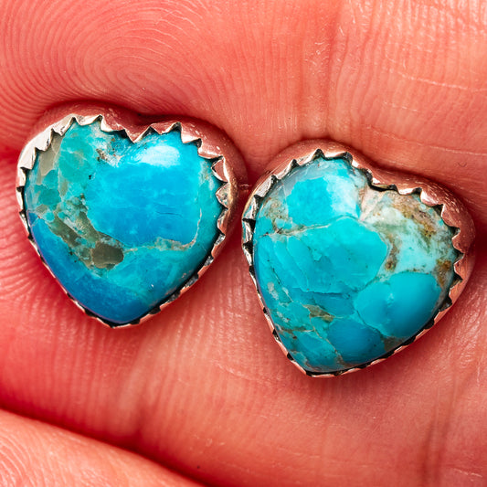 Turquoise heart earrings with textured sterling silver bezel edging.