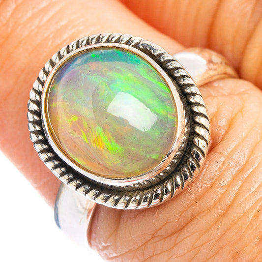 Ethiopian opal ring with oval green-orange iridescent stone, rope bezel, 925 silver