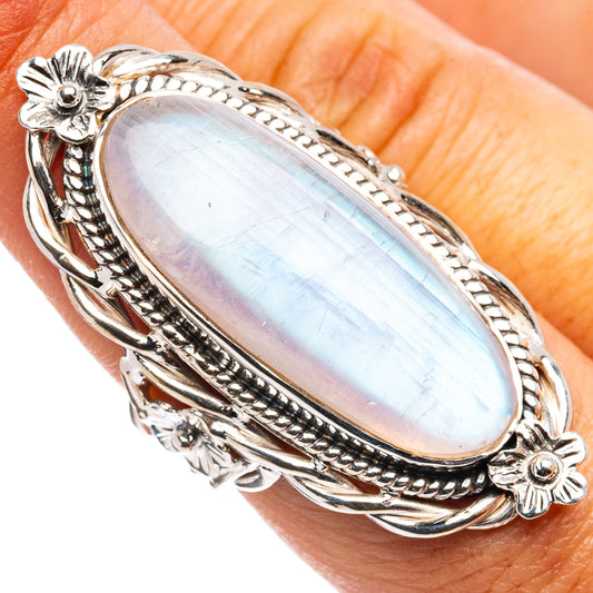 Oval iridescent moonstone ring on finger, .925 sterling silver with floral frame