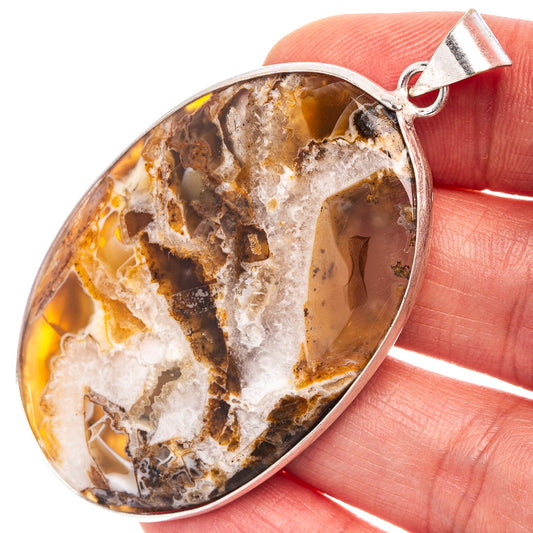 Silver-plated tube agate pendant with oval amber and cream stone, silver bail