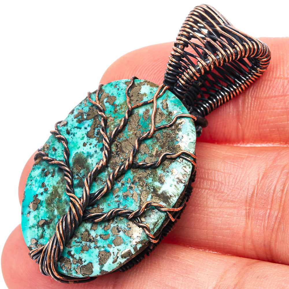 Close-up tree of life pendant: turquoise patina stone with oxidized copper wire tree