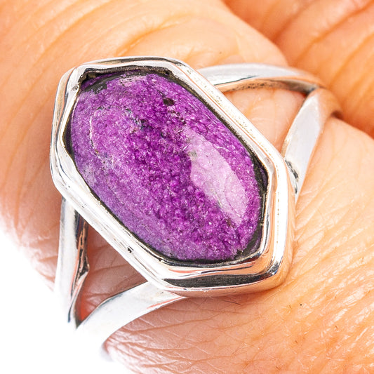 Oval purple gemstone sterling silver ring on finger, close-up of setting.
