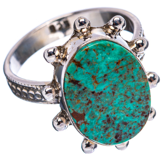 Turquoise cabochon sterling silver ring with decorative cutout metal band