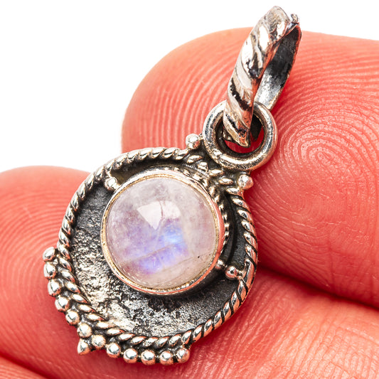 Sterling silver moonstone pendant close-up with round iridescent stone and textured border