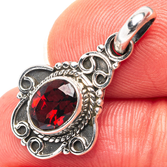Sterling silver garnet pendant with oval red gemstone and ornate scalloped bezel