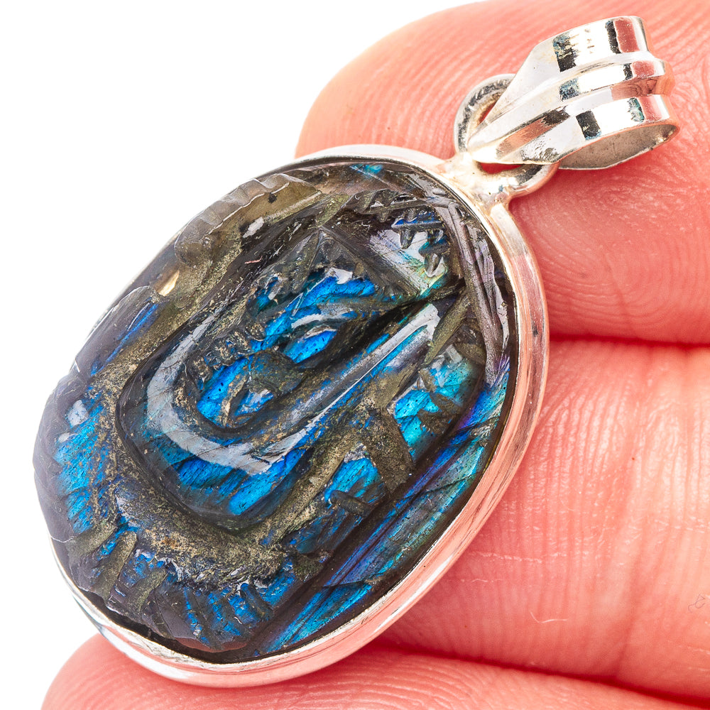 Carved labradorite god pendant with oval bezel, blue iridescent stone in 925 silver