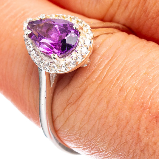 Sterling silver ring with oval amethyst center and cubic zirconia halo, visible setting