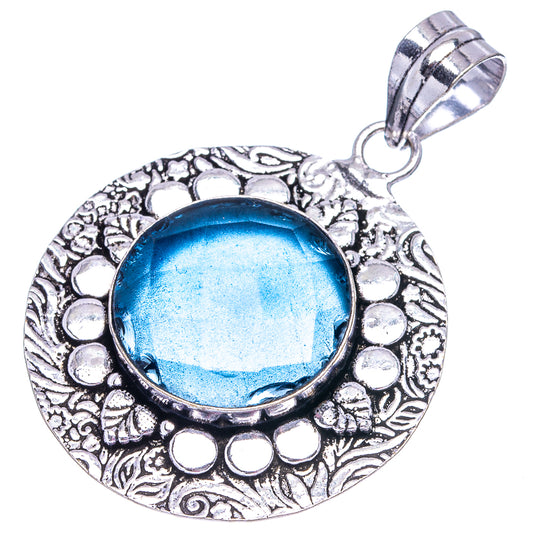 Round blue quartz pendant with detailed silver-tone frame and loop bail