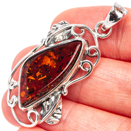 Sterling silver amber pendant with oval Baltic amber stone in ornate leaf setting