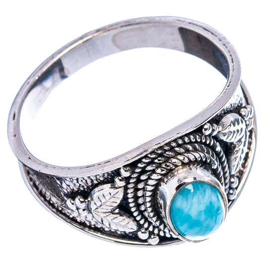 Sterling silver ring with blue round cabochon and raised leaf-and-knot engraving