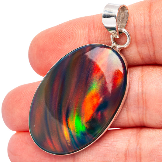 Sterling silver oval opal pendant with rainbow iridescent pattern, top bail in view.