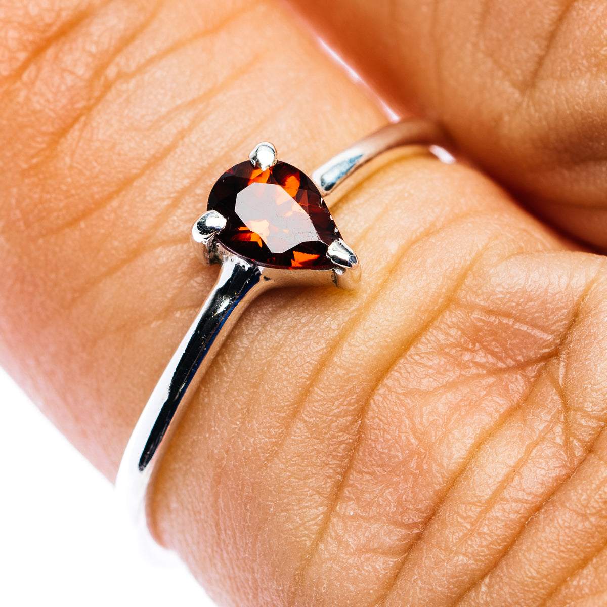 Stackable sterling silver garnet ring with pear-cut red gemstone and 3 prongs