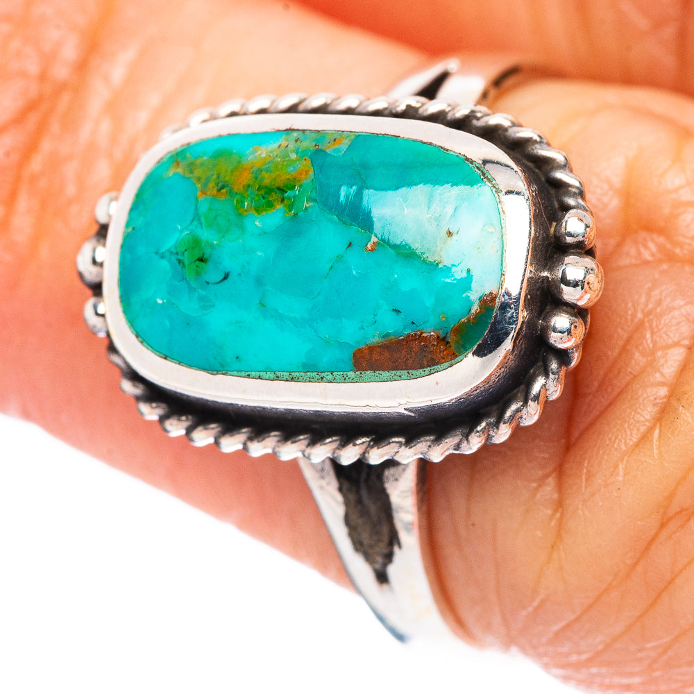 Sterling silver turquoise oval cabochon ring with bead-edge bezel, close-up.